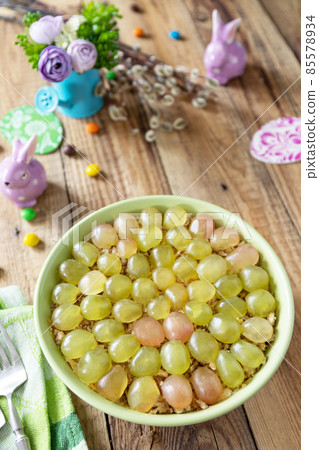 Holiday food, easter salad. Salad with chicken, cheese, walnuts and grapes on a festive table. Holiday food, easter salad. Salad with chicken, cheese, walnuts and grapes on a festive table. 85578934