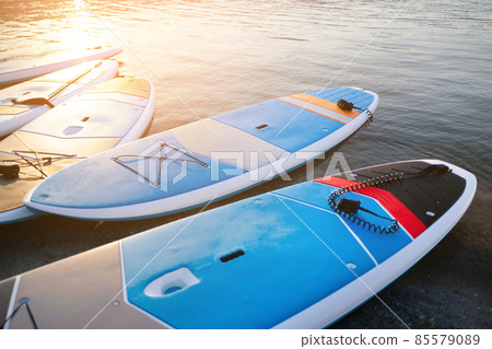 SUP Stand up paddle board on the background blue water. SUP Stand up paddle board on the background blue water. 85579089
