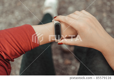 Active sport woman setting up the fitness smart watch for running. Nature and sport healthy lifestyle concept. 85579116