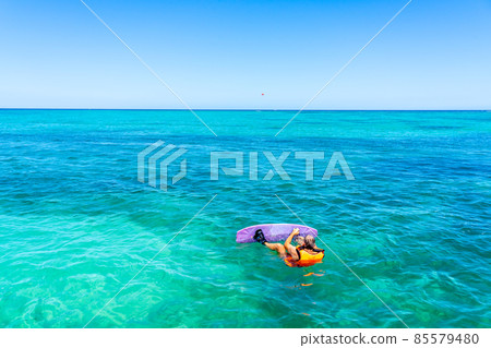 Man preparing for a wakeboard on a sea. Vacation concept, sports holidays, getaway fun with friends and family 85579480