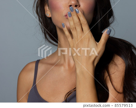 Beauty closeup of brunette lower face with clean skin and evening makeup. The girl looks at the camera and sends an air kiss. Smooth eyebrows and very long eyelashes Beauty closeup of brunette lower face with clean skin and evening makeup. The girl looks at the camera and sends an air kiss. Smooth eyebrows and very long eyelashes 85579513