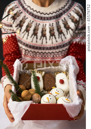 Traditional Christmas stollen made of dried fruits and nuts sprinkled with powdered sugar on the 85579752