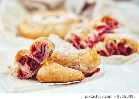 Fresh delicious puff pastry with sweet cherries served on light table 85580093