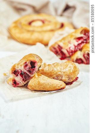 Fresh delicious puff pastry with sweet cherries served on light table 85580095