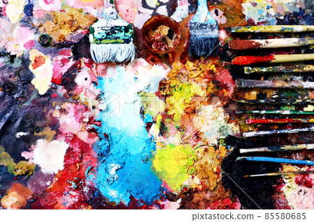 Close up paint brushes on a color full painter in black ground. Close up paint brushes on a color full painter in black ground. 85580685