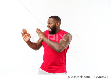 Portrait of young muscular african american male boxer looking aside, punching, standing isolated over grey background. Sport, workout, bodybuilding. Portrait of young muscular african american male boxer looking aside, punching, standing isolated over grey background. Sport, workout, bodybuilding. 85580875