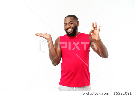 Young sport african american man extending hands to the side for inviting to come Young sport african american man extending hands to the side for inviting to come 85581081