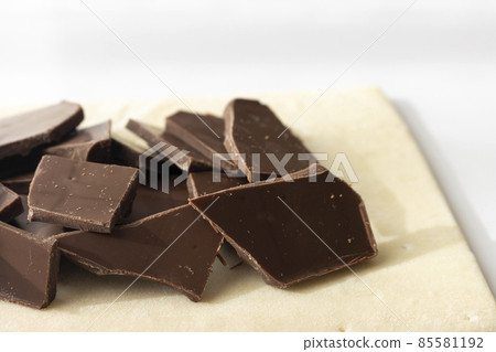 Broken chocolate bar and puff pastry. Image of making chocolate pie 85581192