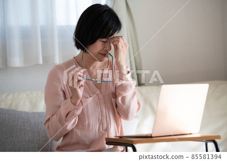 Japanese middle-aged woman tired of working from home Japanese middle-aged woman tired of working from home 85581394