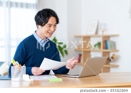 Young man having a video conference on telework Young man having a video conference on telework 85582804