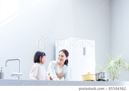 Mom and elementary school students preparing food in the kitchen Kitchen with light 85584362