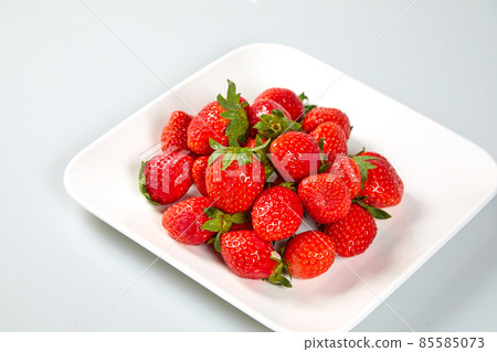 Fresh and tasty fruits and berries on a white bowl Fresh and tasty fruits and berries on a white bowl 85585073