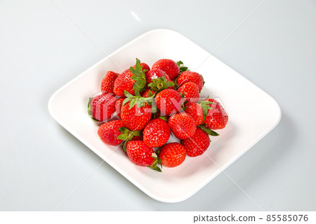 Fresh and tasty fruits and berries on a white bowl 85585076
