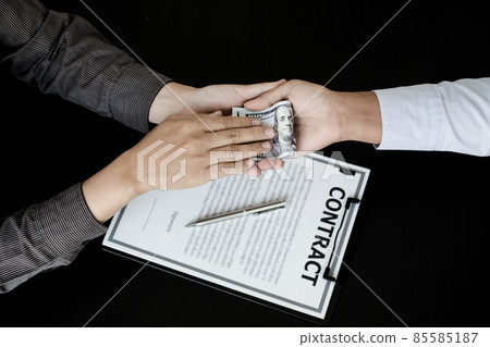 Corruption. Businessmen make an agreement with the money proposed his partner to bribe in the office and make a contract under an agreement. Illegal money fraud The concept of bribery and corruption Corruption. Businessmen make an agreement with the money proposed his partner to bribe in the office and make a contract under an agreement. Illegal money fraud The concept of bribery and corruption 85585187