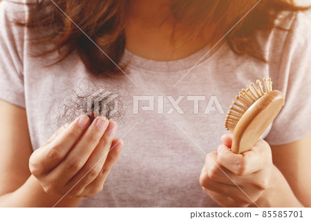 young woman worried about Hair loss problem after comb in hand. problem hormonal disbalance, stress concept. Health care concept young woman worried about Hair loss problem after comb in hand. problem hormonal disbalance, stress concept. Health care concept 85585701