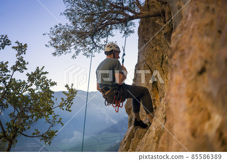 Man is climbing, hiking in the mountains. 85586389