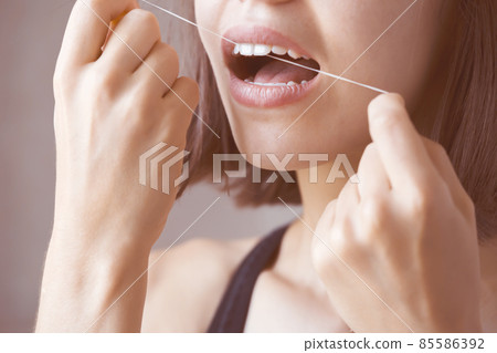 Girl takes care of her health, cleans her teeth. 85586392