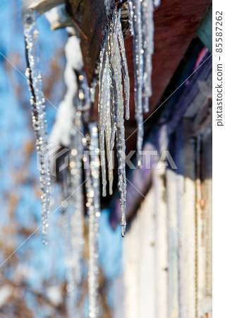 Icicles hanging from roof Icicles hanging from roof 85587262