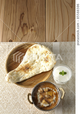 Hot massaman curry, naan and lassie with lots of ingredients such as chicken and peanuts Hot massaman curry, naan and lassie with lots of ingredients such as chicken and peanuts 85588386