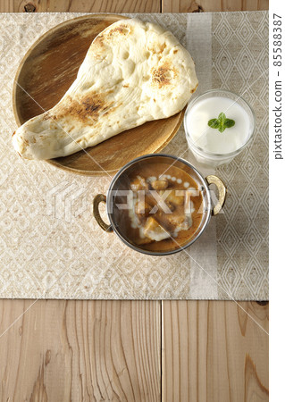 Hot massaman curry, naan and lassie with lots of ingredients such as chicken and peanuts Hot massaman curry, naan and lassie with lots of ingredients such as chicken and peanuts 85588387