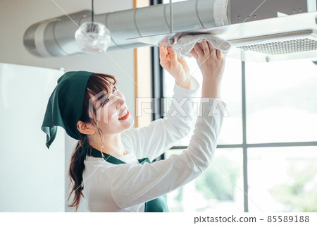 Female cleaning the house (ventilation fan) 85589188