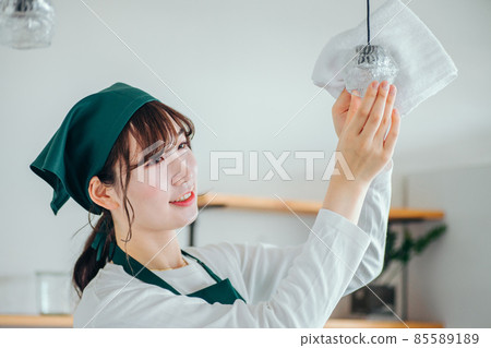 Female cleaning the house (light bulb) 85589189