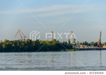 Hoisting cranes at cargo port on the Dnieper river in Kremenchug, Ukraine Hoisting cranes at cargo port on the Dnieper river in Kremenchug, Ukraine 85589569