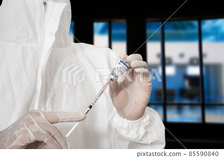Close up doctor holding syringe and using cotton before make injection to patient in medical mask. Covid-19 or coronavirus vaccine. Close up doctor holding syringe and using cotton before make injection to patient in medical mask. Covid-19 or coronavirus vaccine. 85590840