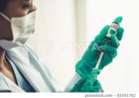 Skillful doctor prepare vaccine proficiently before injection Skillful doctor prepare vaccine proficiently before injection 85591782