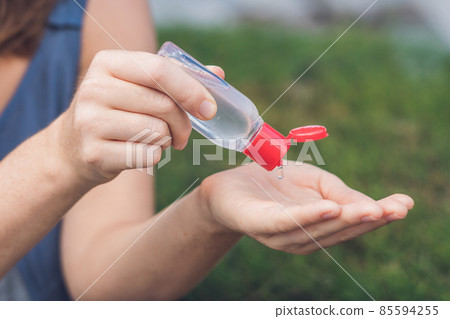 Women's hands using wash hand sanitizer gel Women's hands using wash hand sanitizer gel 85594255