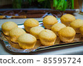 Cool freshly baked vanilla muffins on a metal sheet. 85595724