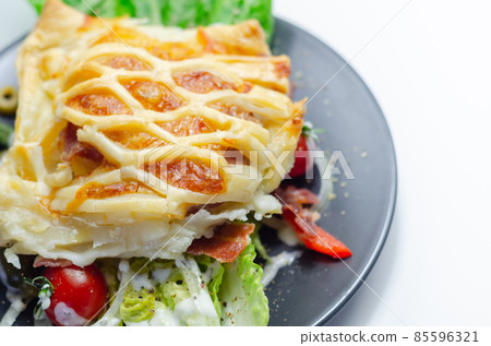 Chicken en croute, chicken breast inner fillets with mature cheddar cheese and beechwood smoked streaky bacon in a puff pastry lattice Chicken en croute, chicken breast inner fillets with mature cheddar cheese and beechwood smoked streaky bacon in a puff pastry lattice 85596321