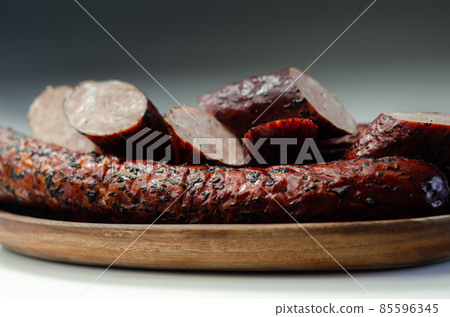 Traditional pork sausage smoked over wood, handcrafted meat product Traditional pork sausage smoked over wood, handcrafted meat product 85596345