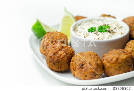 Falafels, gently spiced blend of sweet potato, chickpeas and onion with a sour dip 85596502