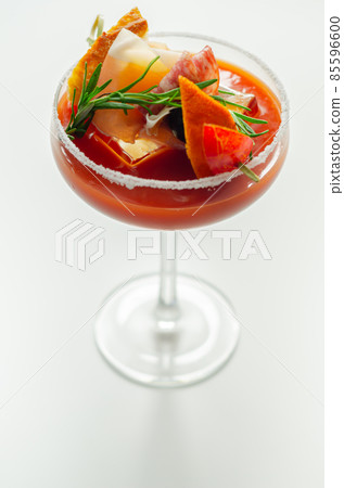 Bloody Mary with interesting decoration with a small snack on top of a cocktail glass Bloody Mary with interesting decoration with a small snack on top of a cocktail glass 85596600