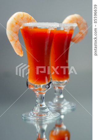 Bloody Mary cocktail prepared with pure vodka, tomato juice and hot pepper sauce, drink decorated with a shrimp Bloody Mary cocktail prepared with pure vodka, tomato juice and hot pepper sauce, drink decorated with a shrimp 85596639