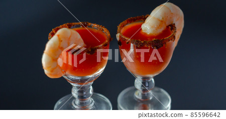 Bloody Mary cocktail prepared with pure vodka, tomato juice and hot pepper sauce, drink decorated with a shrimp Bloody Mary cocktail prepared with pure vodka, tomato juice and hot pepper sauce, drink decorated with a shrimp 85596642