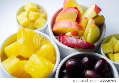 Various set fruits, pineapple, apple, grapes with matured cheddar cheese in bowls 85596705
