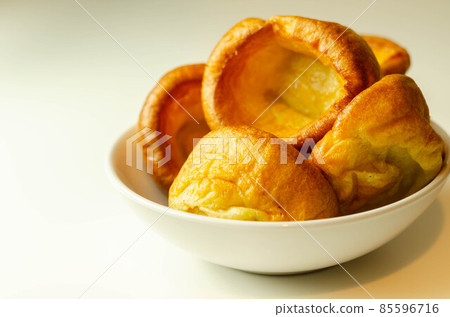 Traditional English Yorkshire pudding, wonderfully crisp and golden baked for a traditional recipe, accompaniment for the perfect Sunday roast Traditional English Yorkshire pudding, wonderfully crisp and golden baked for a traditional recipe, accompaniment for the perfect Sunday roast 85596716