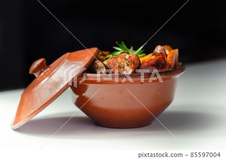 Traditional Polish dish called bigos made of sauerkraut, sausage and mushrooms, food served warm in a ceramic bowl Traditional Polish dish called bigos made of sauerkraut, sausage and mushrooms, food served warm in a ceramic bowl 85597004