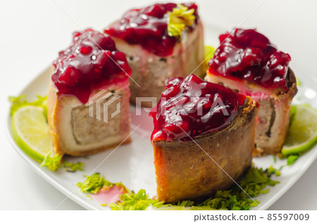 Seasoned British pork, wrapped in crisp, flavoursome pastry served with  beetroot and orange chutney on top Seasoned British pork, wrapped in crisp, flavoursome pastry served with  beetroot and orange chutney on top 85597009