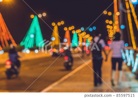 Young couple on the background. Busy traffic on a bridge at night. Blurred focus 85597515