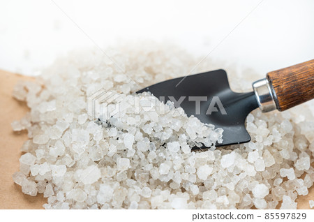 Calcium chloride scooped with a shovel 85597829