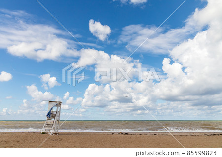 Black sea coast landscape, white rescue tower is under cloudy sky Black sea coast landscape, white rescue tower is under cloudy sky 85599823