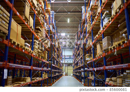 Huge distribution warehouse with high shelves and loaders. 85600081
