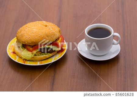 Delicious hamburger and cup of coffee on wooden table 85601628