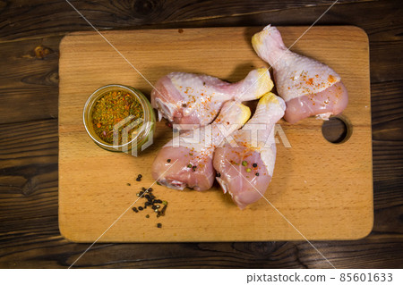 Raw chicken legs with spices on wooden table Raw chicken legs with spices on wooden table 85601633