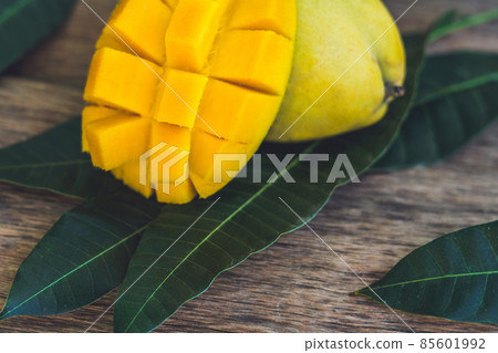Mango and mango leaves on an old wooden background Mango and mango leaves on an old wooden background 85601992