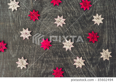 Pieces of sliced dragon fruit in the form of a star on an old withered background Pieces of sliced dragon fruit in the form of a star on an old withered background 85602494
