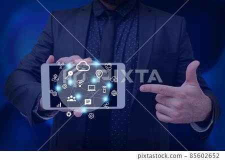 Man holding Screen Of Mobile Phone Showing The Futuristic Technology. Businessman Presenting Cell Phone Inside Room Presenting Modern Automation. Man holding Screen Of Mobile Phone Showing The Futuristic Technology. Businessman Presenting Cell Phone Inside Room Presenting Modern Automation. 85602652